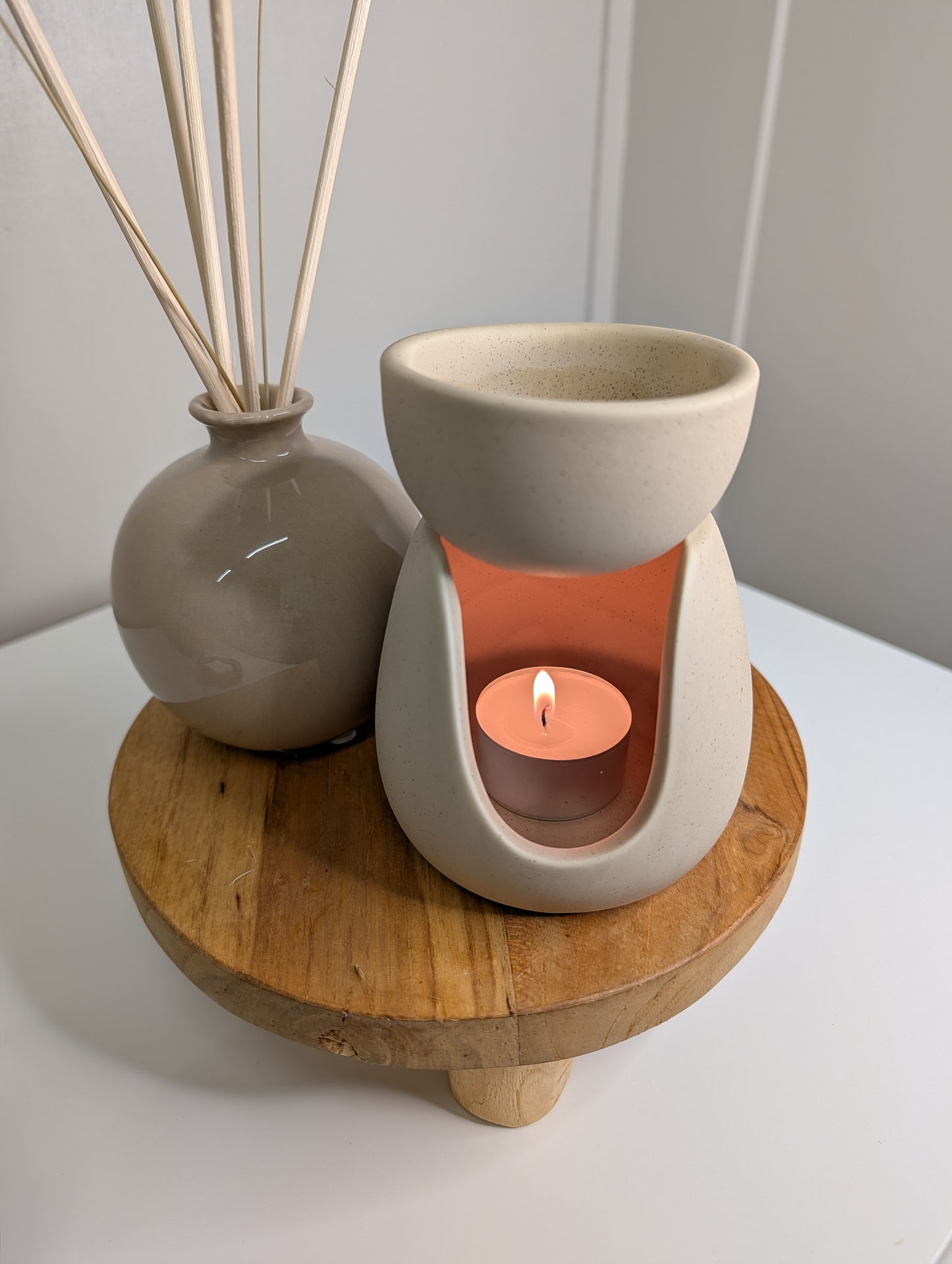 Ceramic Stoneware Wax Warmer elegantly displayed with a tealight candle on a wooden table.